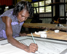 Jean Baptiste Apuatimi at Tiwi Design on Bathhurst Island working on her prints