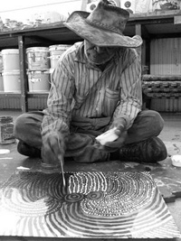 Tommy Mitchell working on his print during the Western Desert Mob print workshop